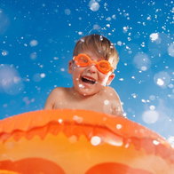 kid in lilo at waterpark