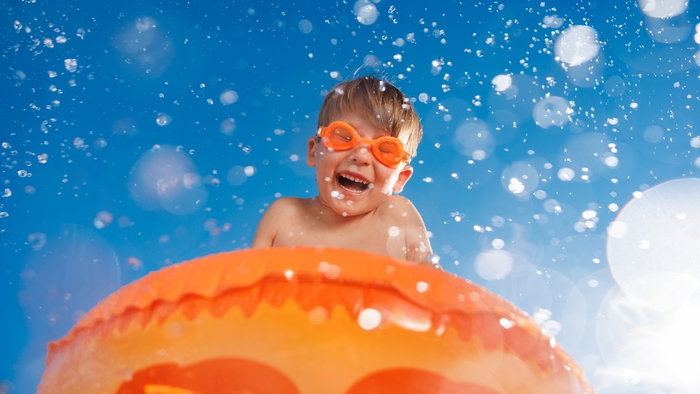 kid in lilo at waterpark