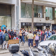 Large queue of people outside an administrative office in Spain.