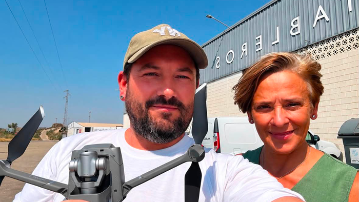 Jonathan Salt holding a DJI Mavic 2 Zoom Drone in the countryside near Albox alongside his spotter, Dolores.