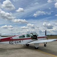 Small aircraft beside hangars and the runway at Casarrubios aerodrome.