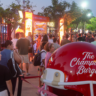 Visitors queue outside food trucks at The Champions Burger festival in Parque de la Estación, Almería.