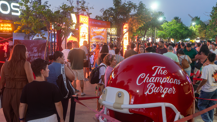 Visitors queue outside food trucks at The Champions Burger festival in Parque de la Estación, Almería.
