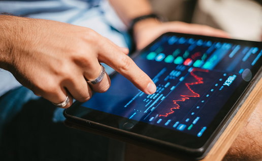 Young man checking stock market on a tablet