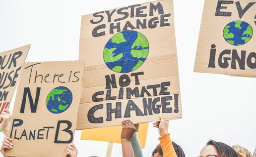 Group of demonstrators on road, young people from different culture and race fight for climate change - Global warming and enviroment concept - Focus on banners