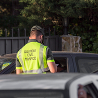 Guardia Civil officer stops driver and tests them for alcohol or drugs.