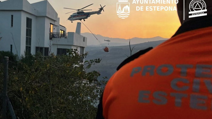 Protección Civil volunteer overseeing evacuation.