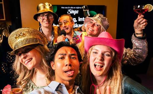 Group of young people taking a selfie photo with party hats