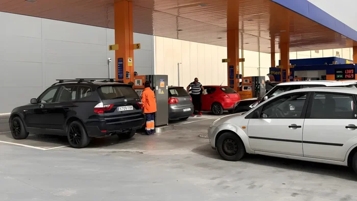 Queuing at a petrol station to fill up before the price hike.