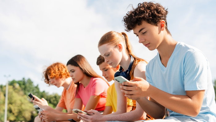 Teenagers on mobile phones