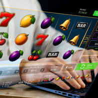 Man on a laptop playing online slot machines