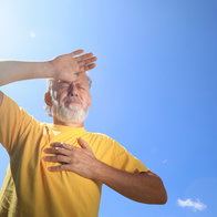 Senior man suffering from heat stroke outdoors.