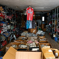 Piles of sports shirts, tracksuits and trainers stored inside a warehouse in Albox.