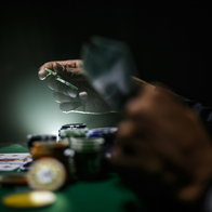 Person sat at casino table with chips in front of them