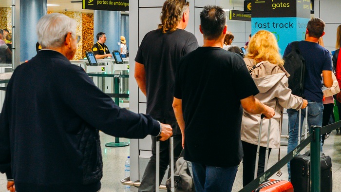 Passengers queue at a boarding gate in Lisbon Airport