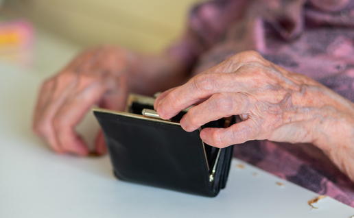 Elderly woman's hands looking through her purse
