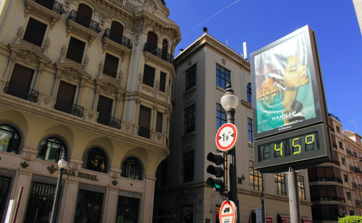Billboard in Granada with a digital thermometer displaying 45 celsius degree at the intersection of Calle Reyes Catolicos and Calle Padre Suarez streets.