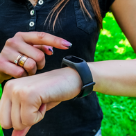 Woman wearing a smart bracelet whilst doing exercise