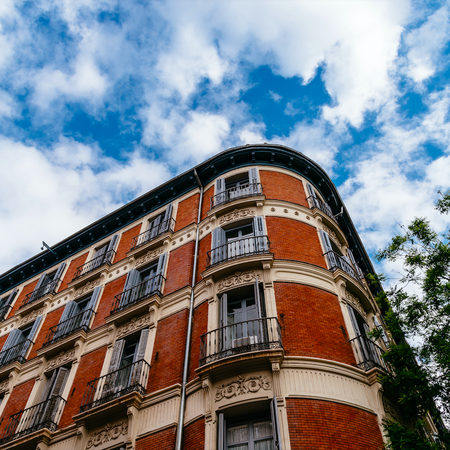 Luxury residential brick buildings in central Madrid. Low angle view of the facade against sky