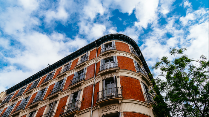Luxury residential brick buildings in central Madrid. Low angle view of the facade against sky