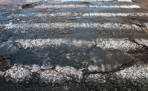 Worn down and unpainted zebra crossing