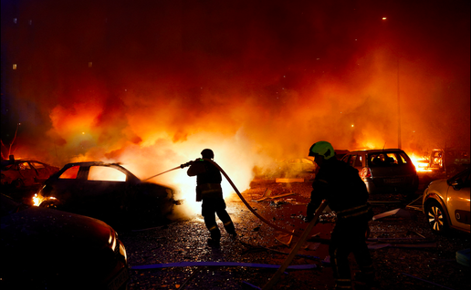 Firefighters trying to put out burning cars from a forest fire