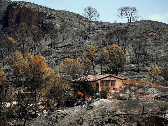 A house surrounded by burnt terrain in Almeria, Spain