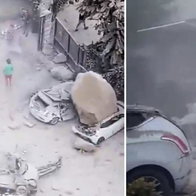 Cars crushed by falling boulders in Naples quake.