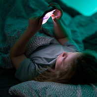 Child using a smartphone as Spain and the EU consider tougher social media protections for minors.