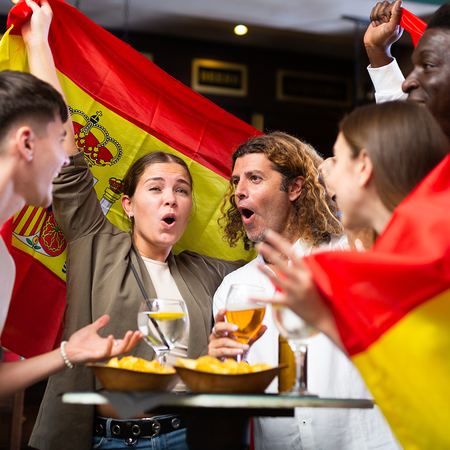 Spain supporters celebrating the 2026 World Cup victory at a local bar.