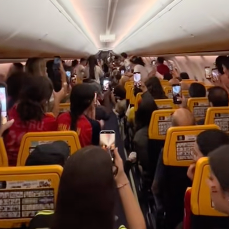 Passengers celebrate aboard a Ryanair flight from Gran Canaria to Madrid after Spain wins the 2026 World Cup.