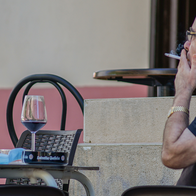 Customer smoking on an outdoor bar terrace in Spain.