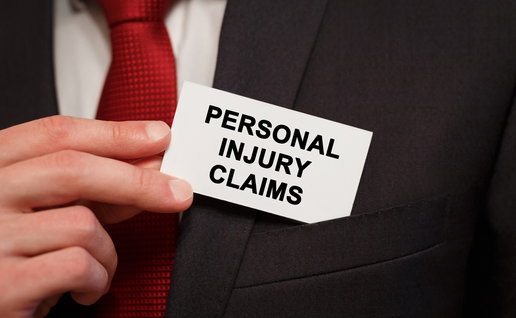 Businessman putting a card in his jacket top pocket with wording Personal Injury Claims