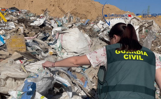 Guardia Civil officer looking through a landfill