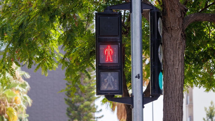 A pedestrian traffic light at a road crossing in Spain, highlighting one of the traffic signal changes included in the country's new driving rules.