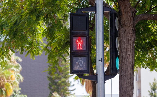 A pedestrian traffic light at a road crossing in Spain, highlighting one of the traffic signal changes included in the country's new driving rules.
