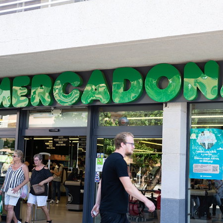 Customers enter a Mercadona supermarket in Spain, where selected stores are opening on Sunday with reduced summer trading hours.