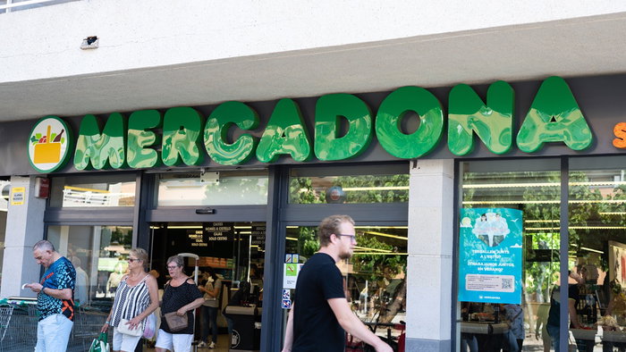 Customers enter a Mercadona supermarket in Spain, where selected stores are opening on Sunday with reduced summer trading hours.