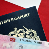 British passport next to a Spanish residency card.