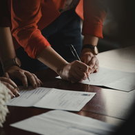 People signing documents.