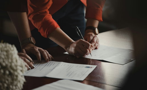 People signing documents.