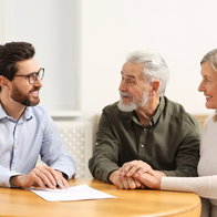 Notary consulting senior couple about Last Will and Testament in office