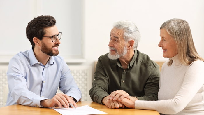 Notary consulting senior couple about Last Will and Testament in office