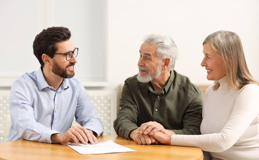Notary consulting senior couple about Last Will and Testament in office
