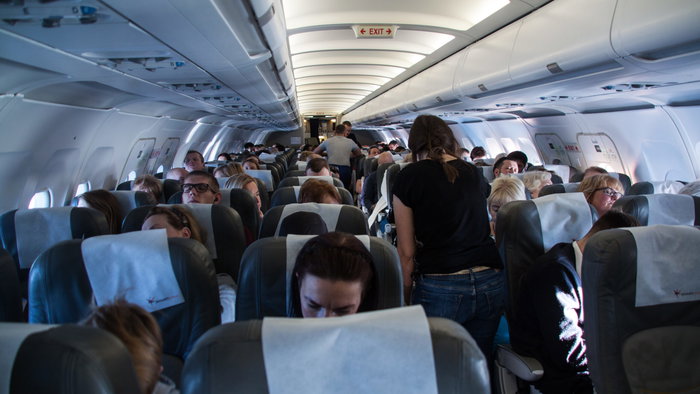 The interior of an airplane filled with passengers