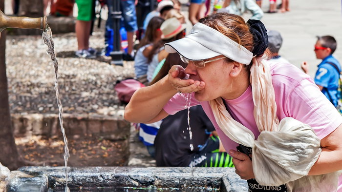 Woman Keeping hydrated during the dust clouds.