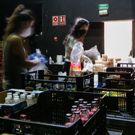 Several volunteers preparing food baskets and bags from the food bank. to support people