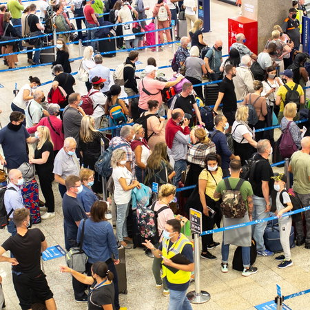 Many people queueing in an airport as flight delayed