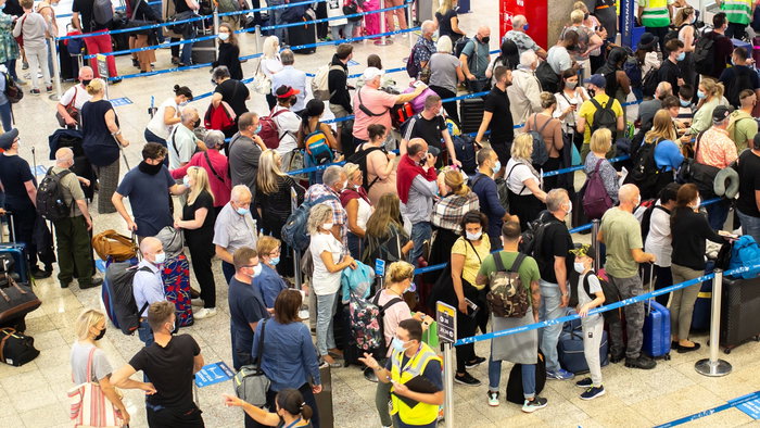 Many people queueing in an airport as flight delayed