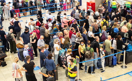 Many people queueing in an airport as flight delayed